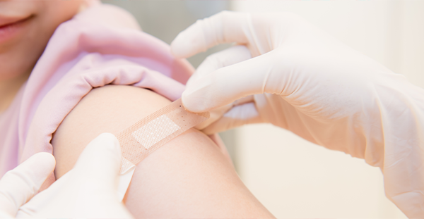 A person getting Band-Aid after taking a vaccine